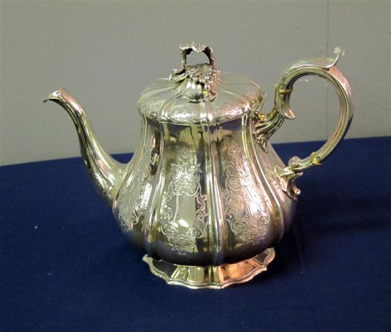 Appraisal: Victorian silver tea pot of circular section with eight panels