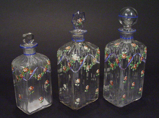 Appraisal: Three fluted glass scent bottles and stoppers all enamelled with