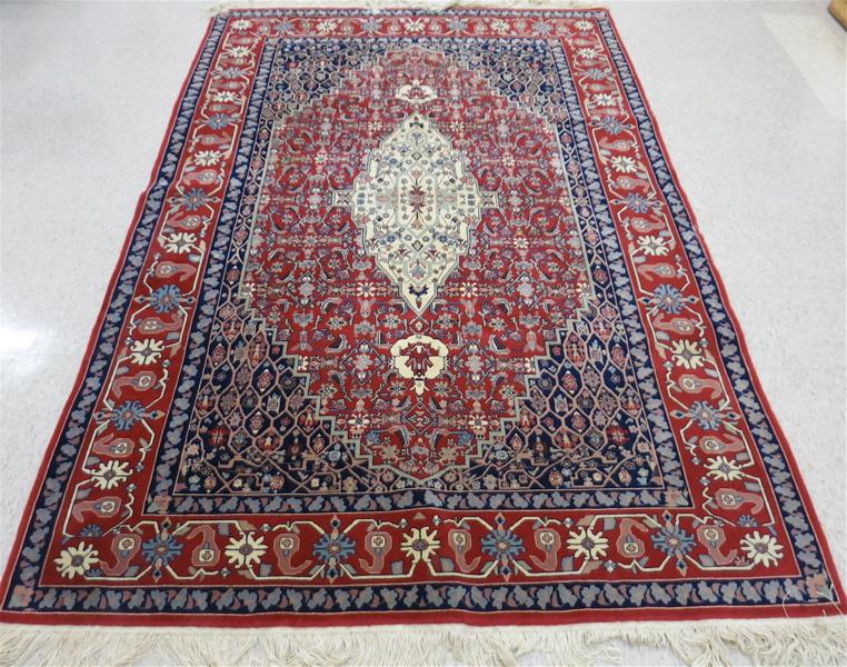 Appraisal: A CONTEMPORARY HAND KNOTTED PERSIAN CARPET central floral medallion and