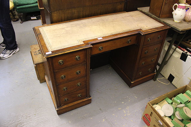 Appraisal: AN EDWARDIAN MAHOGANY BREAK FRONT PEDESTAL DESK with leather inset