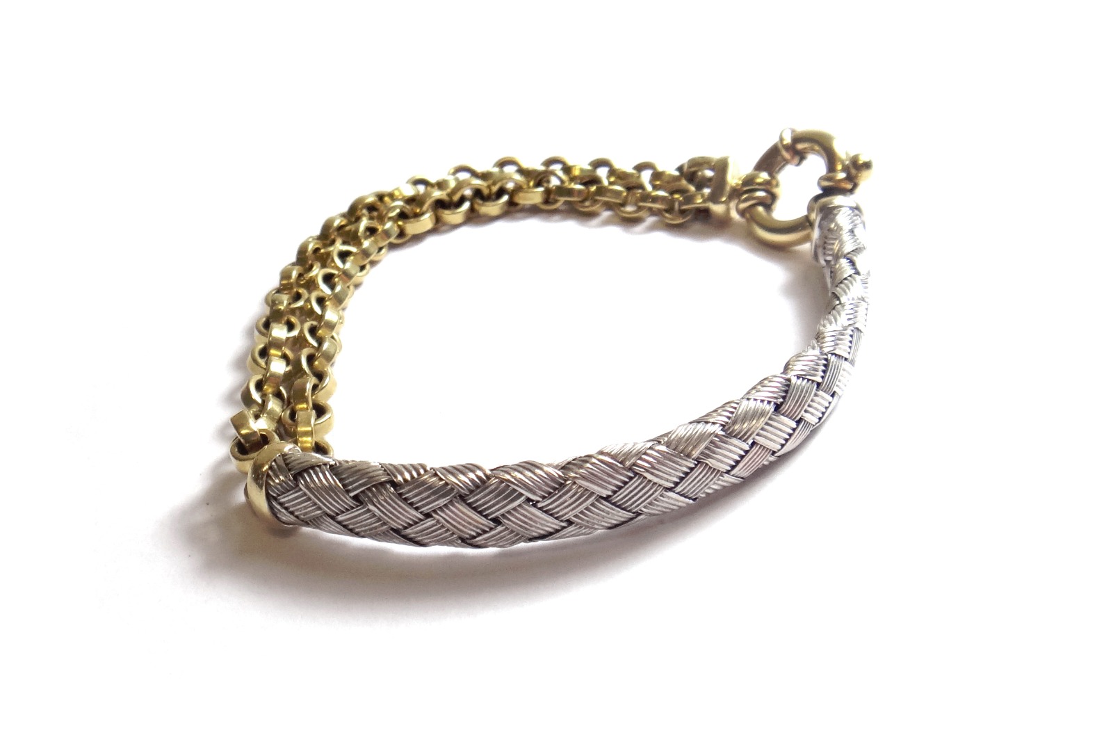 Appraisal: A two colour gold bracelet the front of curved form