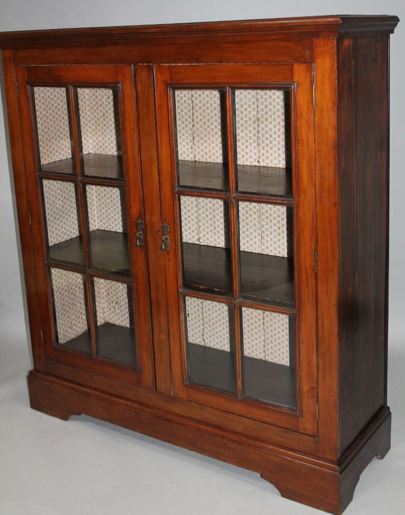 Appraisal: A late thC freestanding bookcase the over hanging moulded top