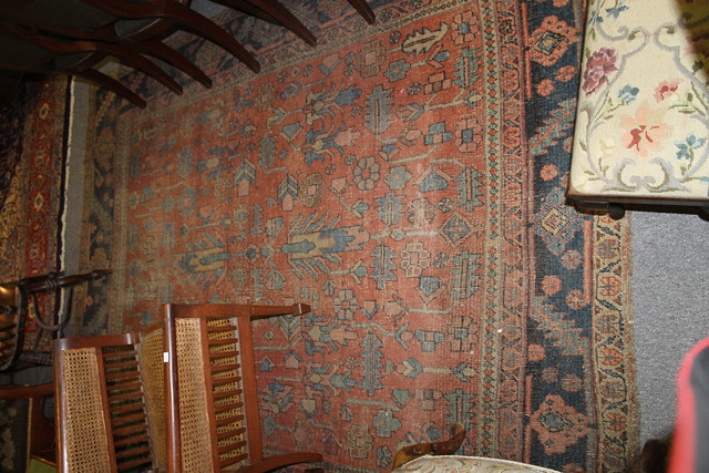 Appraisal: A HAMADAN LARGE RUG with red ground central panel and