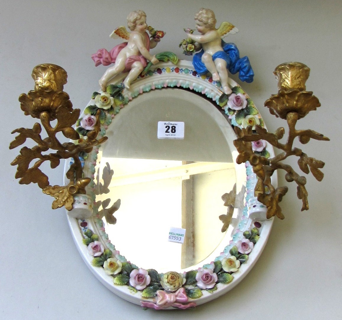 Appraisal: A Sitzendorf porcelain oval wall mirror th century with cherub