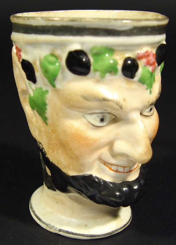 Appraisal: th Century Staffordshire Bacchus mask cup with silver lustre handle