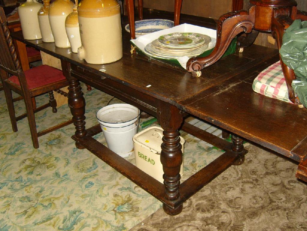 Appraisal: An Old English style oak draw leaf dining table raised