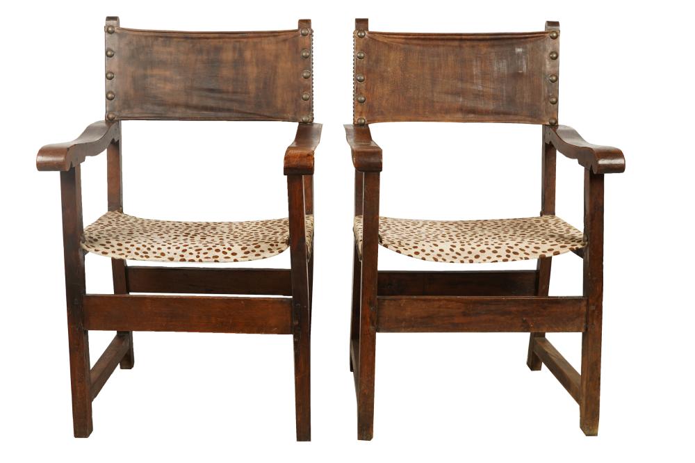 Appraisal: PAIR OF CONTINENTAL CARVED WALNUT HALL CHAIRSwith leather painted hide