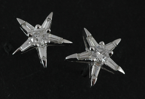 Appraisal: A pair of diamond star earrings Centrally set with a