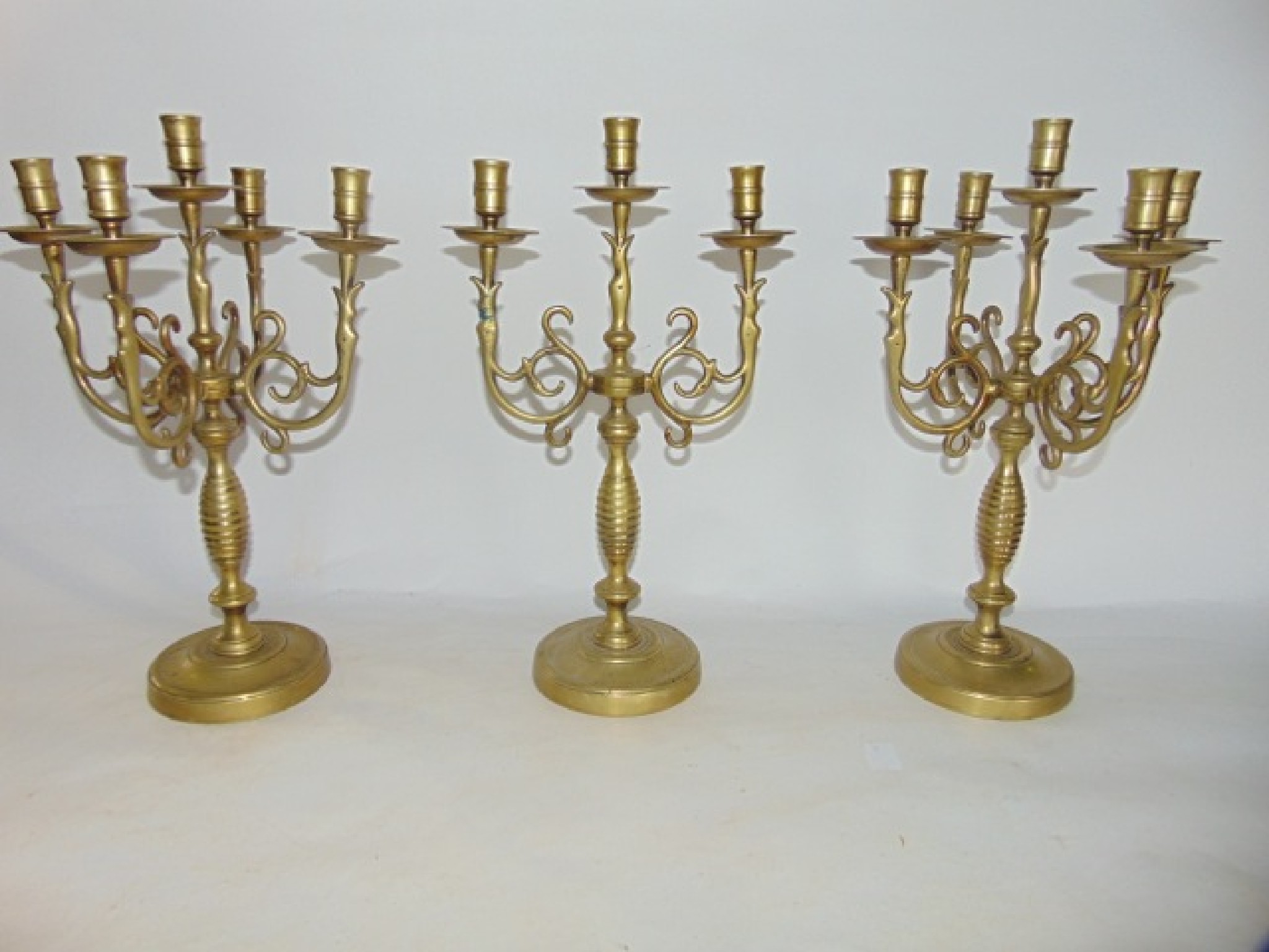 Appraisal: A pair of good quality old brass five divisional candelabrum