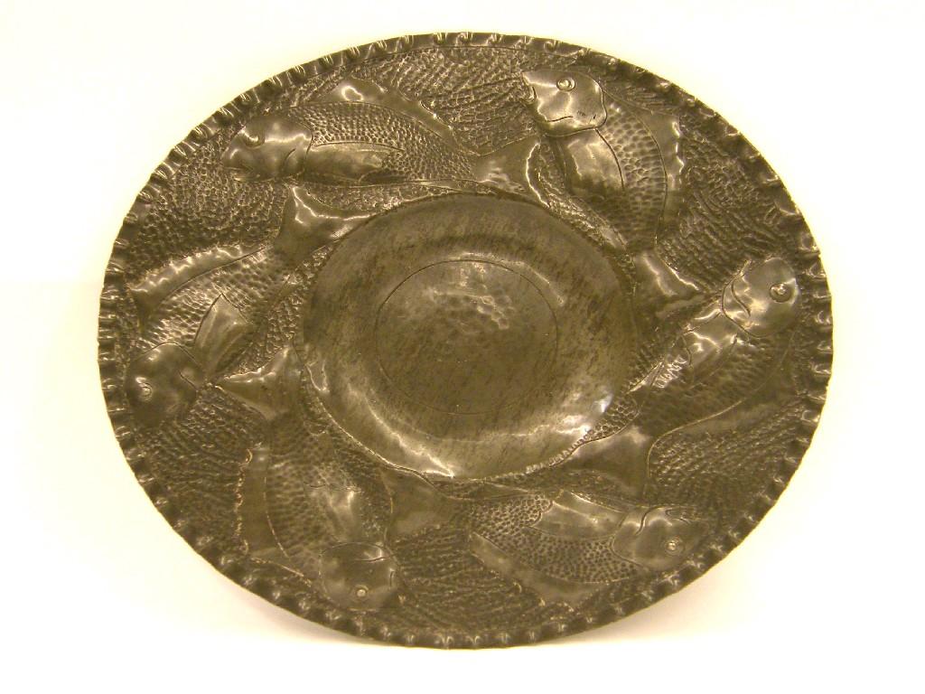 Appraisal: Newlyn style circular embossed pewter charger the wide border decorated