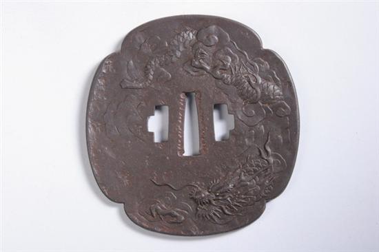 Appraisal: JAPANESE IRON TSUBA Edo period Mokko-gawa shime-ji carved in relief