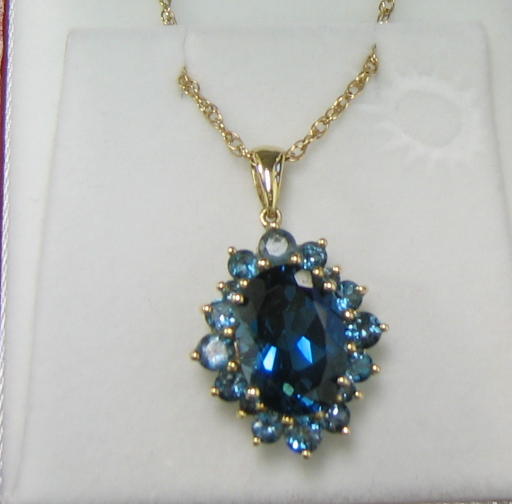 Appraisal: BLUE TOPAZ RING EARRINGS AND PENDANT k yellow gold pendant