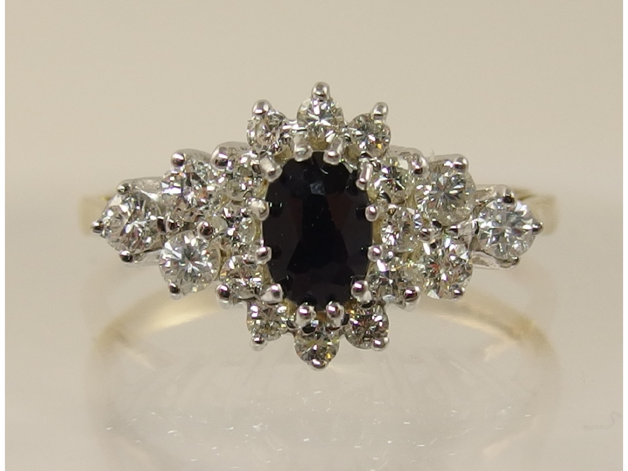 Appraisal: A ct sapphire and diamond cluster ring with a combined