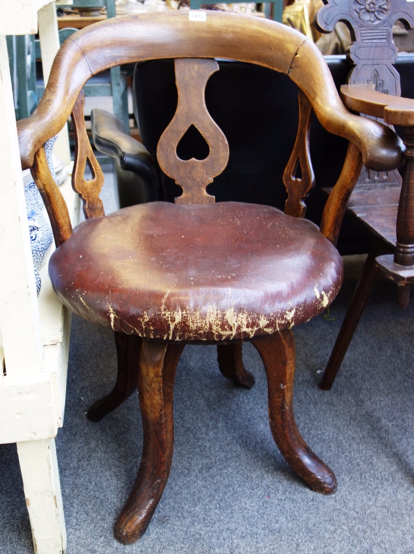 Appraisal: A Victorian oak framed tub back swivel office chair on