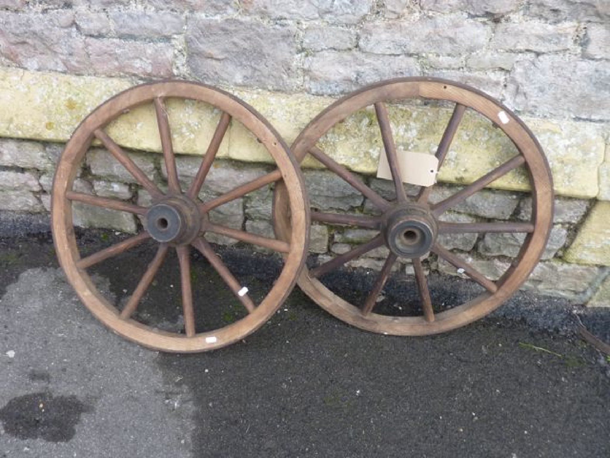 Appraisal: A pair of small vintage cartwheels with timber spokes and