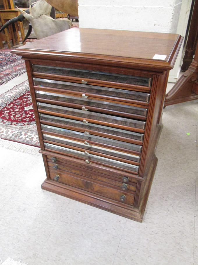 Appraisal: A VICTORIAN WALNUT ELEVEN-DRAWER SPOOL CABINET American last quarter of