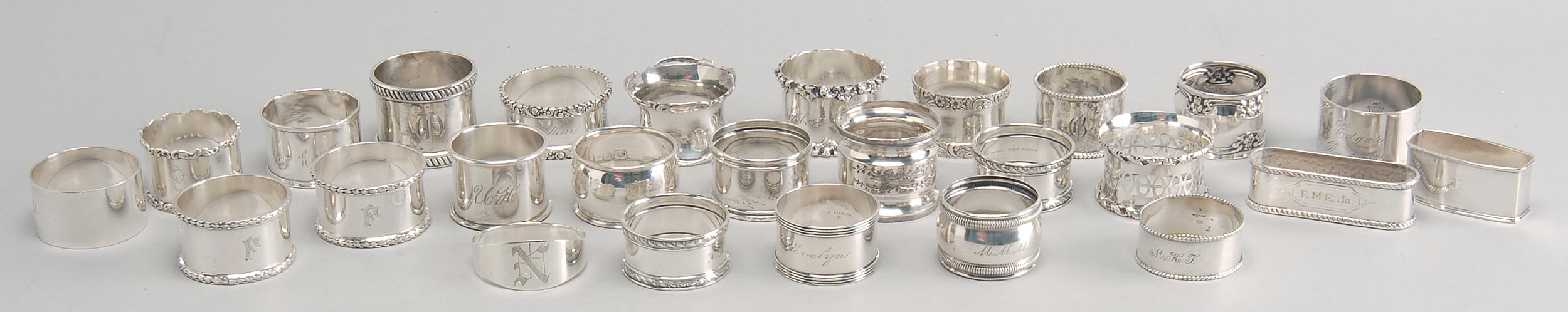 Appraisal: TWENTY-FIVE STERLING SILVER NAPKIN RINGS by various makers Together with