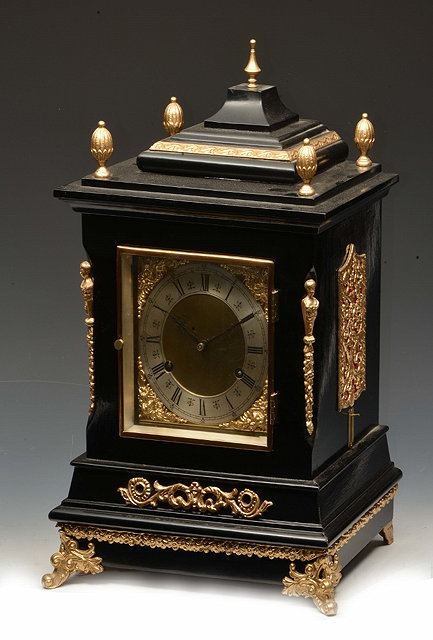 Appraisal: AN AMERICAN EBONISED TABLE CLOCK the square brass dial with