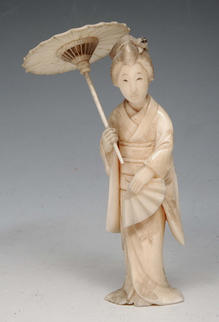 Appraisal: A JAPANESE CARVED IVORY FIGURE of geisha with parasol high