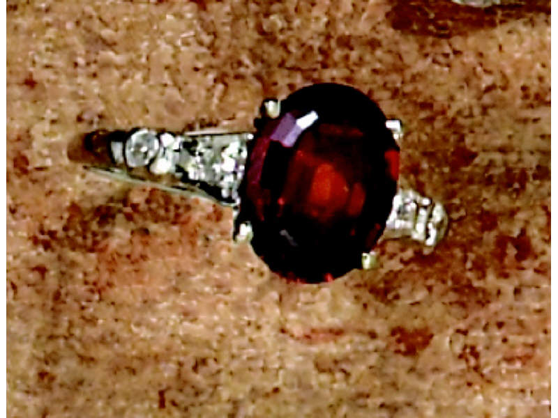 Appraisal: GARNET AND DIAMOND RING k white gold ring with oval