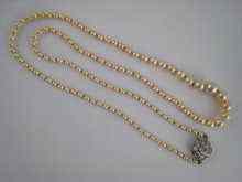 Appraisal: A graduated natural pearl necklace with old cut diamond clasp