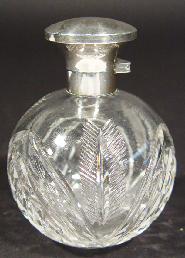 Appraisal: Globular cut glass scent bottle with silver mount and lid