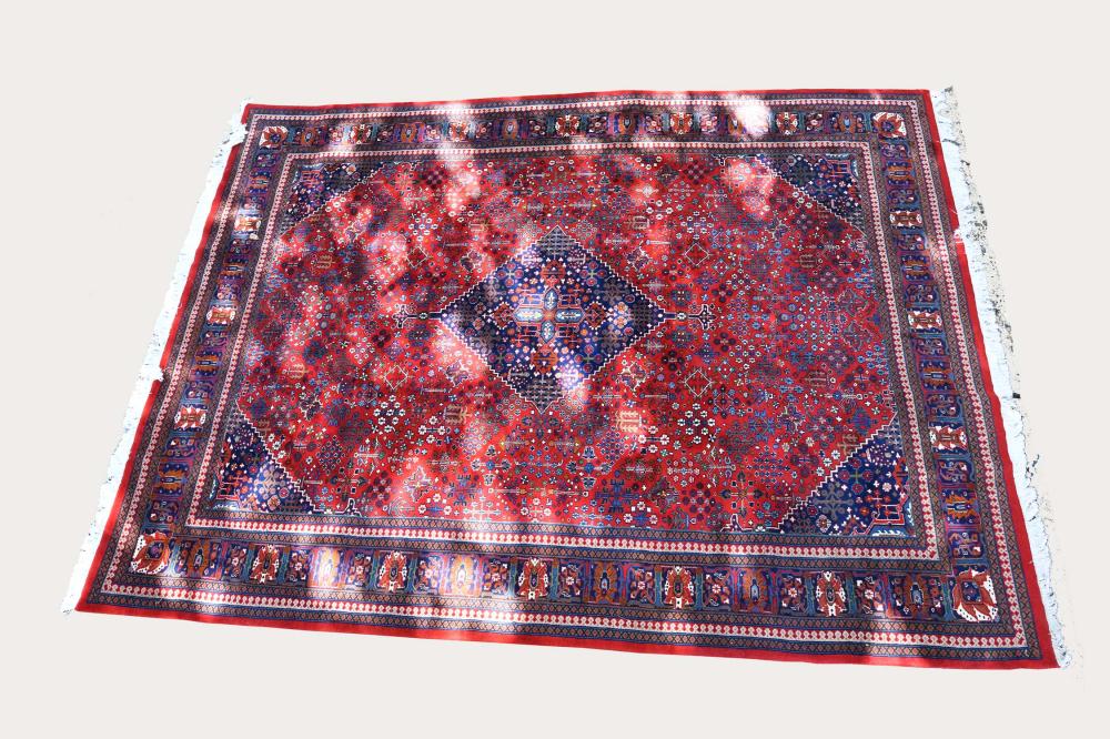 Appraisal: CONTEMPORARY PERSIAN STYLE CARPETThe red field with a blue center