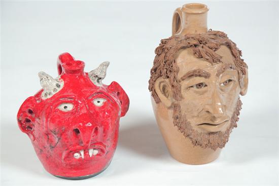 Appraisal: TWO GROTESQUE JUGS American th century pottery Abraham Lincoln signed