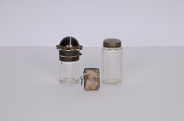 Appraisal: Two silver topped glass dressing table bottles the first with