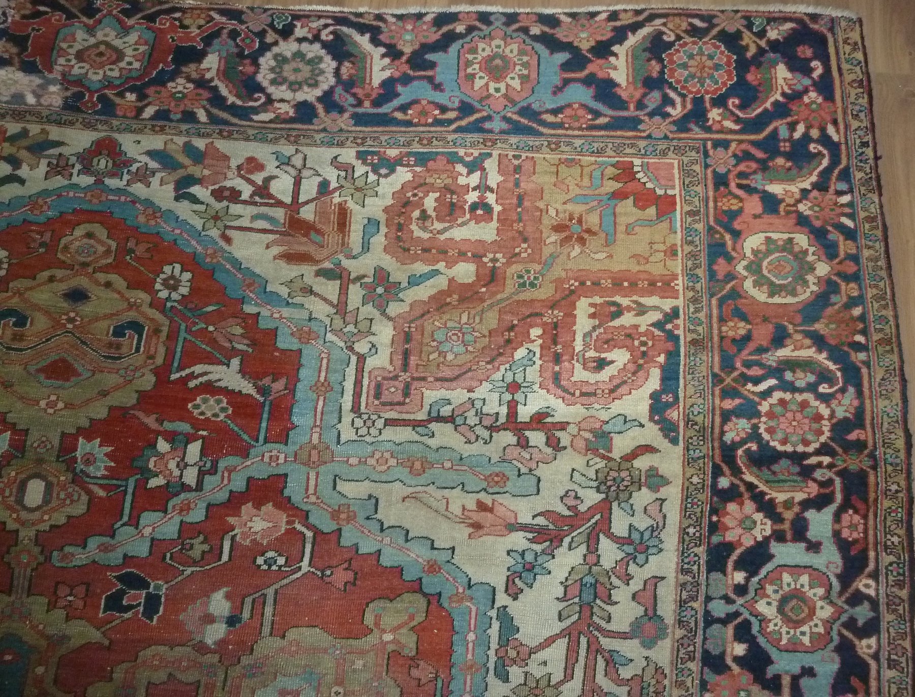 Appraisal: A Heriz carpet with central geometric medallion on a red