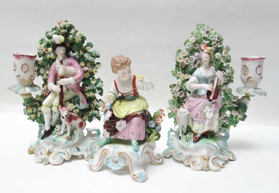 Appraisal: CHELSEA PORCELAIN FIGURINE AND PAIR OF FIGURAL CANDLESTICKS the figurine