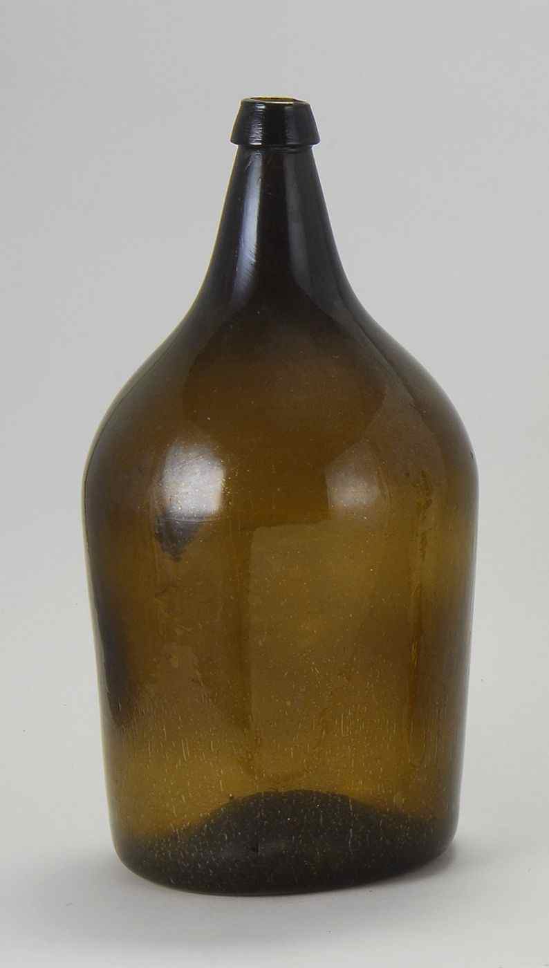 Appraisal: FREE-BLOWN GLASS BOTTLE th CenturyIn deep amber Height ''