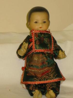 Appraisal: An Armand Marseille bisque head Oriental baby doll with brown