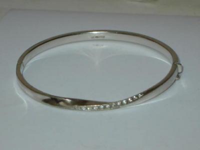 Appraisal: A CT WHITE GOLD BANGLE of hinged form the twisted