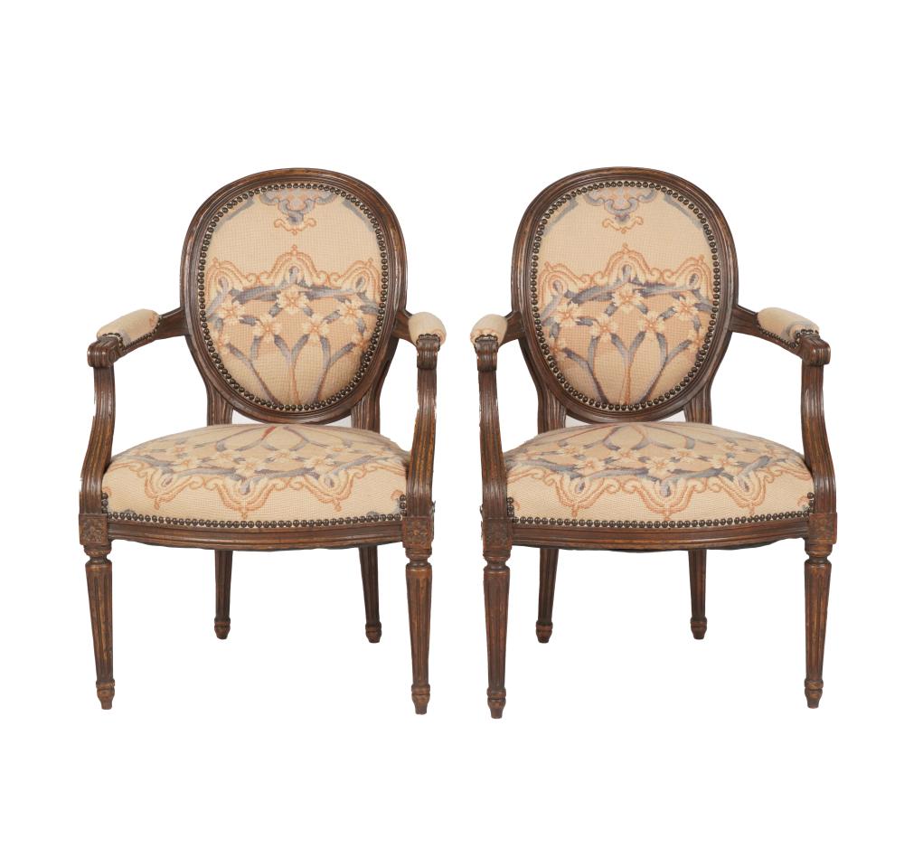 Appraisal: PAIR LOUIS XVI PROVINCIAL-STYLE FAUTEUILScovered with machine-made needlepoint inches wide