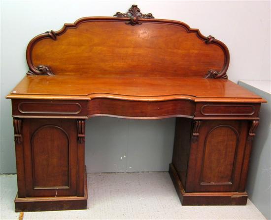 Appraisal: Victorian mahogany pedestal serpentine sideboard with carved raised back the