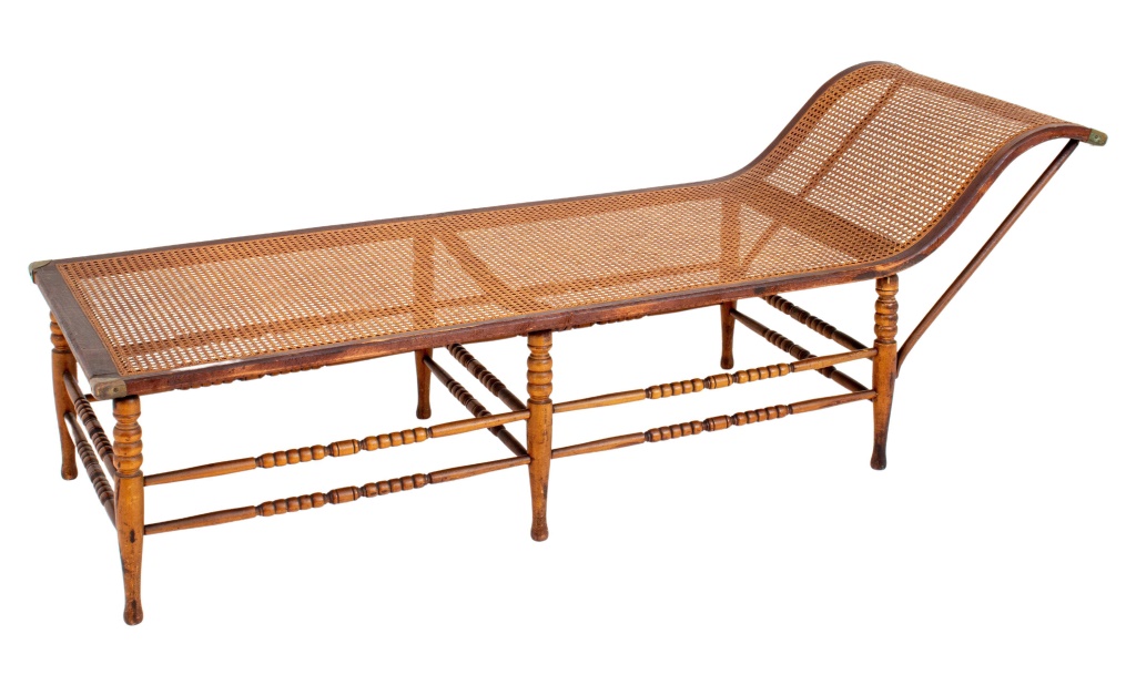 Appraisal: DUTCH COLONIAL BRASS-MOUNTED CANED WOODEN CHAISE Dutch colonial brass-mounted caned