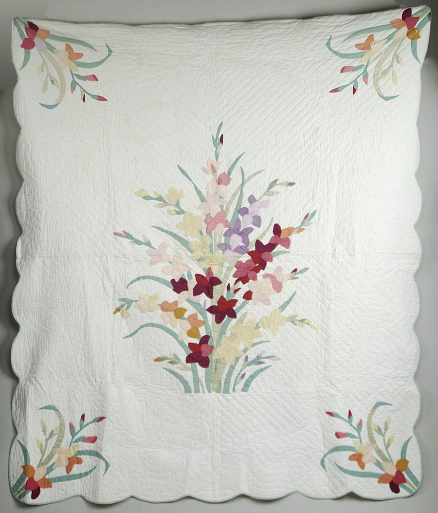 Appraisal: APPLIQUED PATCHWORK QUILT WITH GLADIOLAS Colorful quilt has a central