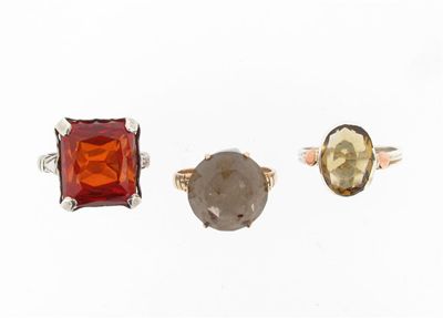 Appraisal: A rectangular cut garnet set ring And two rings set