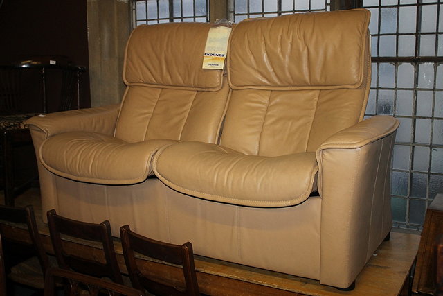 Appraisal: AN EKORNES STRESSLESS TWO SEATER TAN LEATHER SOFA each seat