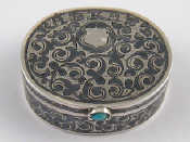 Appraisal: A niello silver oval pill boxwith cabochon thumbpiece Bears Russian