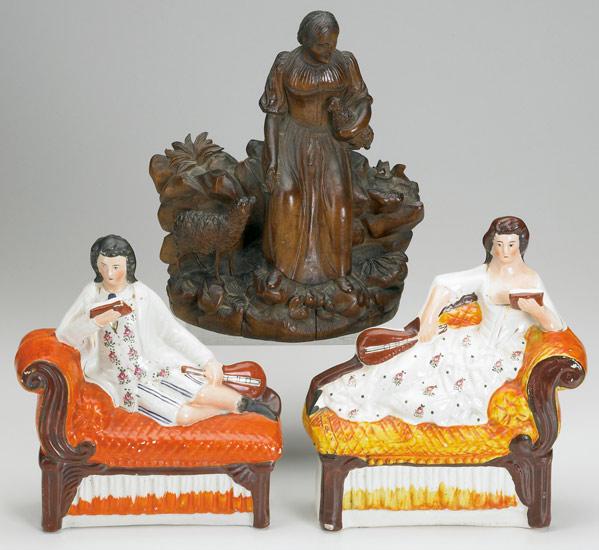 Appraisal: VICTORIAN DECORATION Pair of Staffordshire figures of a reclining man