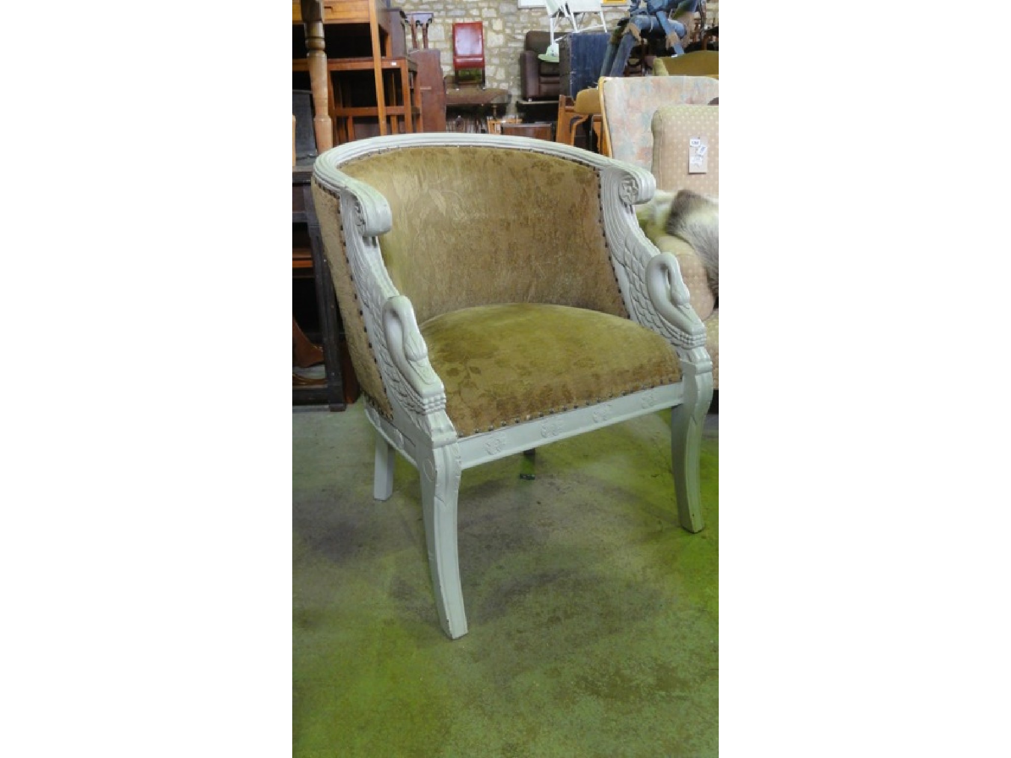 Appraisal: A French Empire style tub chair with carved swan detail