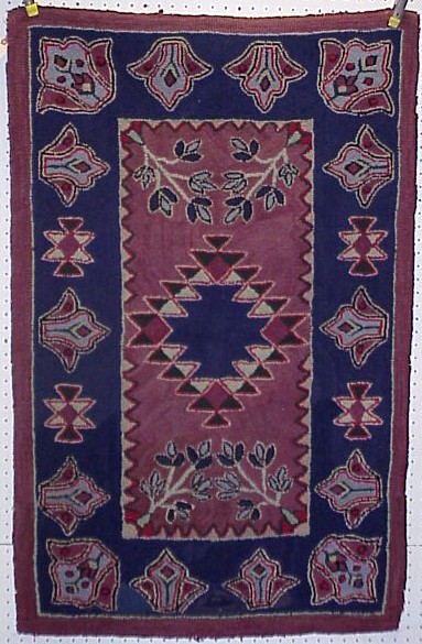 Appraisal: Hooked rug with blue ground stylized floral and center stepped