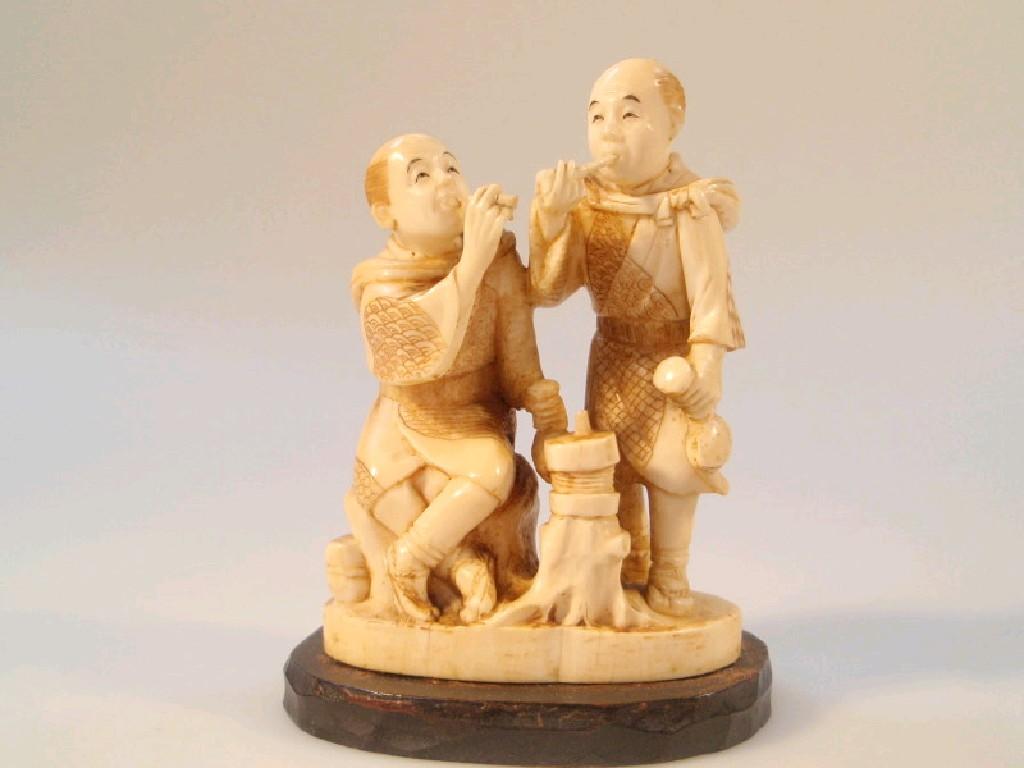 Appraisal: A Japanese Meiji period ivory figure group carved as two