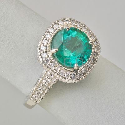 Appraisal: EMERALD AND DIAMOND K WHITE GOLD RING Round brilliant cut