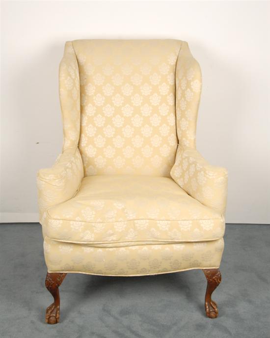 Appraisal: A Chippendale-style Wingback Chair upholstered in pale yellow brocade with