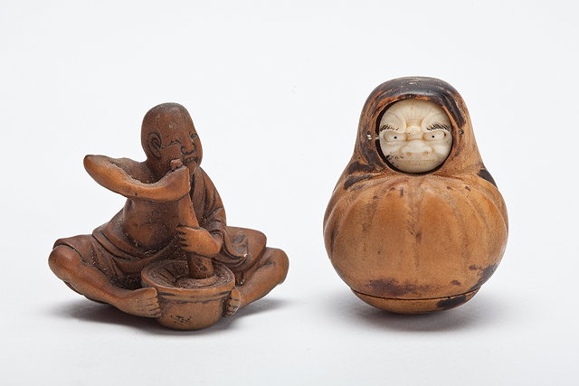 Appraisal: A JAPANESE WOOD NETSUKE man sitting mixing mochi with pestle