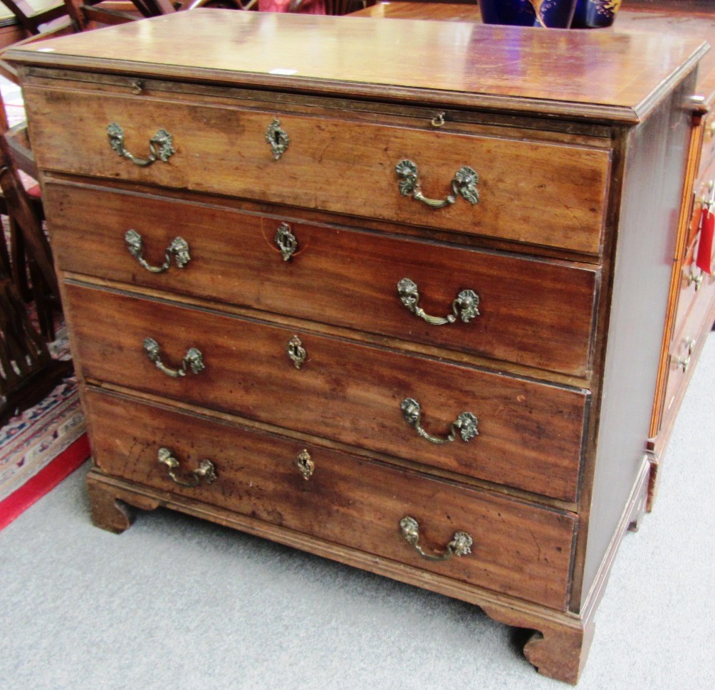 Appraisal: A George III mahogany chest the brushing slide over four