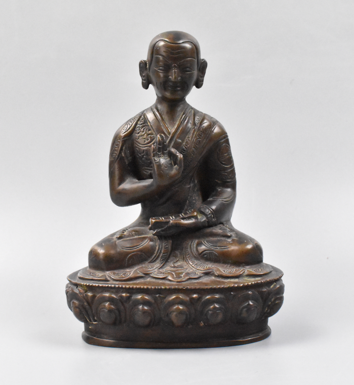 Appraisal: A Chinese seated bronze buddha th C He sits smiling